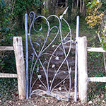 Frameless garden gate based around stylised plants