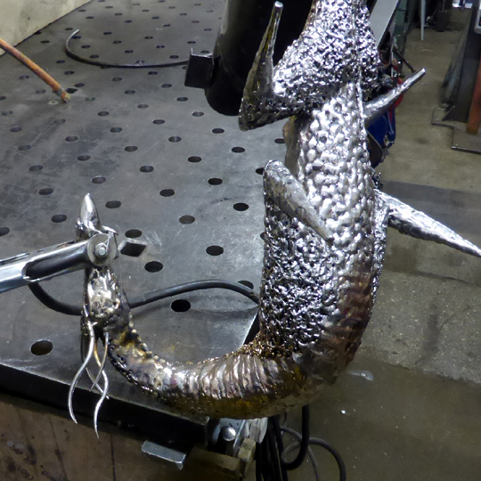 Stainless steel dragon sculpture being made