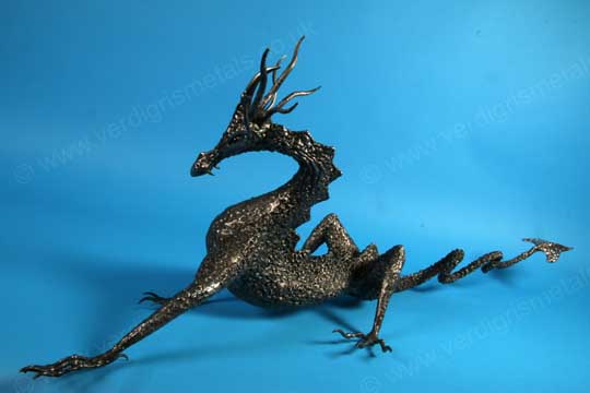 blackened and textured steel dragon sculpture