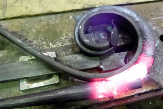 Shaping bronze door handle on a jig