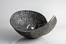 Heavily textured iron bowls with an ammonite and seashell design 