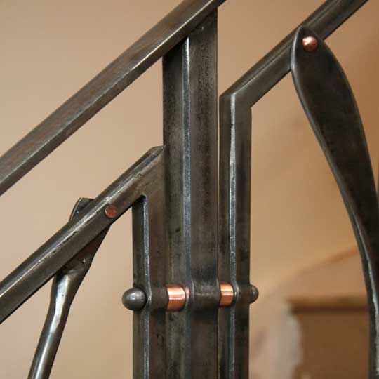 The copper rivets and spacers contrast nicely with the darker steel