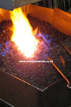steel being heated in a coke forge