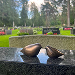 Bronze bird sculptures as grave stone decoration in Finland