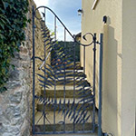 Pedestian gate based around fern sculptures