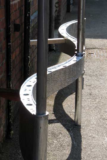 Textured steel cantilevered gate