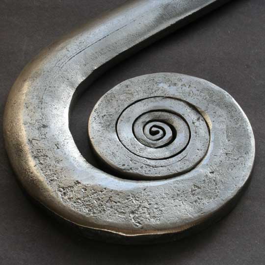 The handrail bullnose shows its naturally forged texture