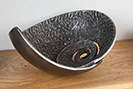 Heavily textured iron bowls with an ammonite and seashell design 