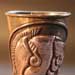 A copper vessel with a repousse'd face of Alexander the Great