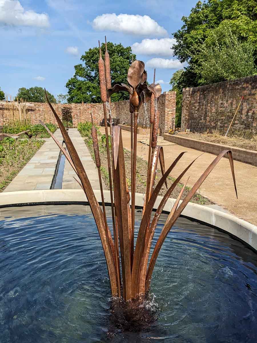 This copper water feature and founatin was made using bulrushes and a stylised iris This copper water feature and founatin was made using bulrushes and a stylised iris