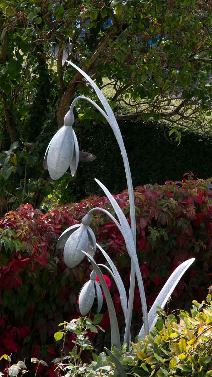 This snowdrop sculpture perfectly complements its English cottage garden setting This snowdrop sculpture perfectly complements its English cottage garden setting