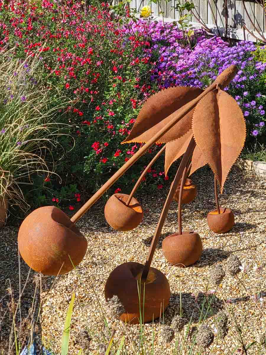 Rusty steel cherries as garden sculpture Rusty steel cherries as garden sculpture