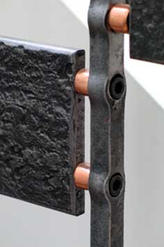 Textured steel and copper staircase detailing