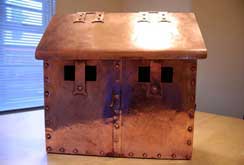 A riveted and textured copper letterbox