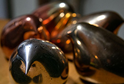 Polished copper and bronze bird sculptures
