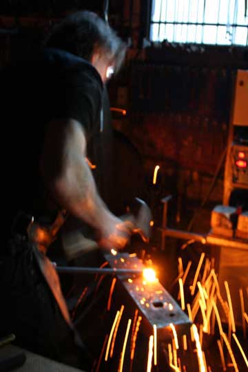 blacksmith working at an anvil
